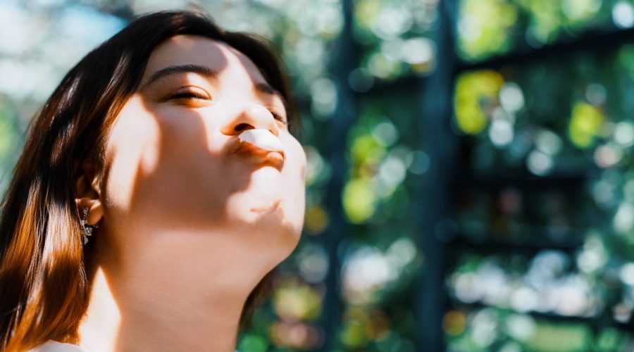 Woman with eyes closed and sun on her face